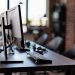 No people at call center helpdesk with multiple monitors in office